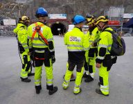 Scan survey staff members about to enter tunnel with safety gear on